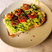 Avocado toast with a lot of olive oil at Plantate Cafe in Madrid