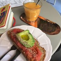 Avocado and tomato on toast, mango smoothie   at Plantate Cafe in Madrid