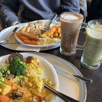 Two full plates with an almond matcha and an oat mocha on the side 😋  at HILTL - Sihlstrasse in Zurich