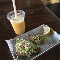 Amazing Avocado Toast & Summer Sun Smoothie. What a great little cafe at E+ROSE Wellness Cafe - Gulch in Nashville