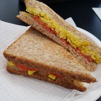 Sandwiche with scrambled tofu curcuma tomato and vegan cheese at Radagast Vegan Bakery in Rome