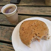 Apologies, started eating it already! Huge sausage bap and coffee with oat milk at Sally's Place - Kiosk in Malvern