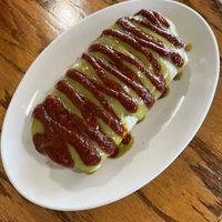 guisado burrito with soy chorizo smothered in their red and green sauce  at La Cabana de Raya in Astoria