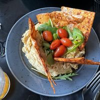 Hummus with spiced pita, arugula and grilled grape tomatoes   at Korova in Athens