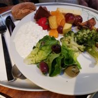 My friend's plate - broccoli, lettuce, olives, fruit salad, cottage cheese, whole wheat bread... at Tibits - Seefeldstrasse in Zurich