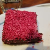 Vegan, gluten-free brownie with coconut shreds on top at Tibits - Seefeldstrasse in Zurich