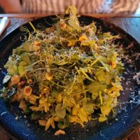 Orzo dish with peas & courgette and hazelnuts and a salad on top at Love Shack in East London