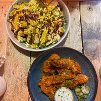 Caesar salad and buffalo wings.   at Love Shack in East London