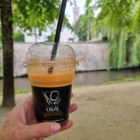 Fresh juice, belfry in background at The Olive Street Food  in Bruges