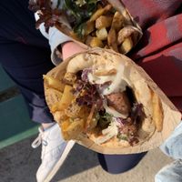 Top is veggie pita, bottom is burger pita. Both come with greens and fries.  at The Olive Street Food  in Bruges