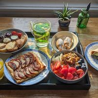 chicken curry wrap; chocolate croissants; a pastry with warm spiced apples; toast with butter, homemade jam, hummus, and vegan Nutella (chocolate hazelnut spread); yogurt with frui at Vegan B&B Valkenbos in The Hague