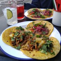 Tacos with oyster mushrooms (front) or with red beans (back) and agua de limon at Taco Santo in Ghent