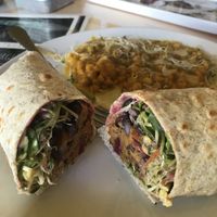 Veggie burger in a wrap with chickpea dhal on the side  at The Sunshine Food Co in Cape Town