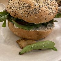 Bagel with vegan ricotta, heura chikn and ruccola  at Religion Coffee in Madrid