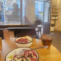 Pink granola, seasonal fruit,  coconut yoghurt topped with almond butter at Wild & The Moon - Amelot in Paris