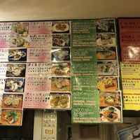 Green signs showing vegan rolls at Sushi Roll Double Quotation IKI in Osaka