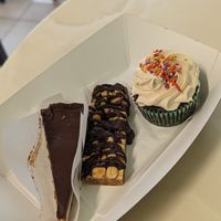 Cheesecake, Snickers, Peanut Butter Frosted Cupcake at Dina's Vegan Deli & Desserts in West Palm Beach