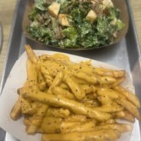 Best cheese fries ever and steak Cesar salad 🤤  at Dina's Vegan Deli & Desserts in West Palm Beach