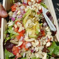 Quinoa Salad - Mixed greens, tomatoes, red onions, quinoa, almonds, avocado and a lemon-blood orange vinaigrette at Daily Blend in Traverse City