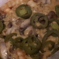 Cheese fries added jalapeños and sautéed mushrooms  at Trilly Cheesesteaks in New Orleans