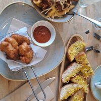 Cheezy jackfruit chips (top left), cheezy garlic bread (top right), cauliflower fritters (bottom). ALL GLUTEN FREE!!! at Sage Vegan Cafe in Crawley