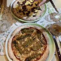 Vegan blue cheese, vegan mozzarella, with caramelized onions and capers (on top). Vegan mozzarella, mushrooms and green peppers (bottom). Toppings are amazing, dough is okay   at La Pepiniere in Florence