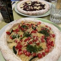 At the back vegan blue cheese, front the pesto. Dough very tough .   at La Pepiniere in Florence