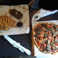 Pizza and seitan steak at Veganga in Moscow