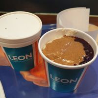 Cashew milk porridge with almond butter and fruit compote at LHR - Leon - T2 in West London