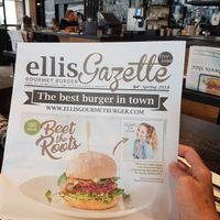 Advertising for their vegan burger on their own gazette at Ellis Gourmet Burger in Leuven