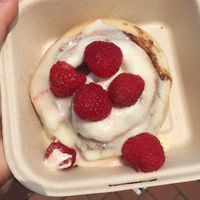 Cinnamon roll with cream cheese frosting and raspberries.   at Cinnaholic in Baltimore
