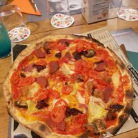 Vegan pizza with cheese and fake meats at Yolo Pizza in Valencia