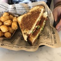 Vegan grilled cheese with tomato and avocado with a side of tots. at The Grilled Cheeserie in Nashville