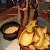 Burger wrap and potatoes with bravas sauce at Amarre 69 in Barcelona