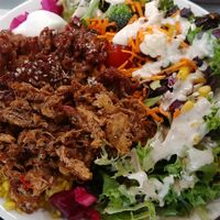 Plate: Side Salad with tahini dressing, schwarma and general Tao for the vegan meat and yellow rice at Juste Falafel in Montreal