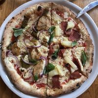 Plant-based chicken on left, Hawaiian with plant-based smoked ham on right    at Manso Pizzeria in Barcelona