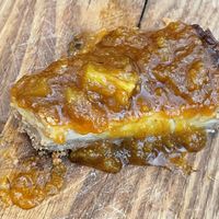 The delicious cheesecake. We never ate something closer to this. The pineapple jam on top, the middle part is creamy and not too sweet and the crunchy cookie is on top! 🤤  at SOIL Vegan Cafe - West in Amsterdam