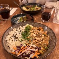 Peanut Butter Curry with smoked tofu. carrots. peas. broken beans. flcgeolets, furnip, siaw, peanuts, conander and rice  at SOIL Vegan Cafe - West in Amsterdam