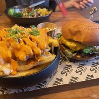 Kimchi loaded fries with the cheezy burger  at SOIL Vegan Cafe - West in Amsterdam