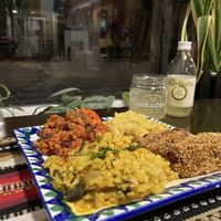 A plate of Chili, risotto, dahl and croquettes with ecological kombucha 👌🏼  at El Piano in Granada