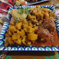 Tortilla de patata, guiso, curry de calabaza y albóndigas de soja at El Piano in Granada