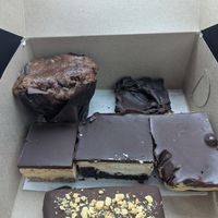 Top: Banana chocolate chip muffin, Decadent brownie 
Bottom: Nanaimo bar, Maple cream bar, Peanut butter chocolate brownie crunch bar, Snickers bar at The Vegan Pantry in Barrie