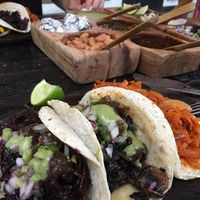 Tacos de hongos (mushrooms) and tinga de zanahoria (marinated carrots) with taco de jamaica (hibiscus) and vegetales (mixed veg) in background. And all the salsas and beans   at El Itacate in Sayulita