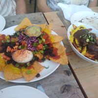 Nachos and poutine, a few bites taken already at Lola Rosa - Places des Festivals in Montreal