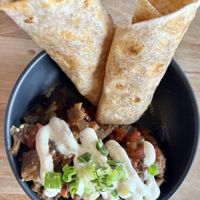 Eggplant bharta ~ Flame roasted eggplants, simmered tomatoes, garam masala spice blend served with toasted flatbread and cilantro sprouts. Yum!   at Lola Rosa - Places des Festivals in Montreal
