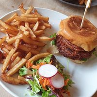 Cajun burger with fries and side salad at Lola Rosa - Places des Festivals in Montreal