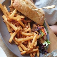 CheeseSteak Sandwich with fries and side salad at Lola Rosa - Places des Festivals in Montreal
