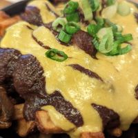 Poutine -- Black bean & mushroom gravy
topped with homemade queso
marinated button mushrooms &
green onio at Lola Rosa - Places des Festivals in Montreal