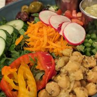 Rosa Salad -- Mixed greens, chickpeas marinated with grilled
cumin and lemon confit, tomatoes, bell peppers,
green onions, carrots, red cabbage, marinated
olives, cucumbers, ban at Lola Rosa - Places des Festivals in Montreal