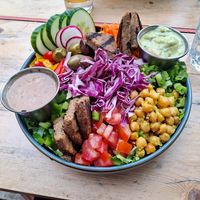 Rosa Salad: mixed greens, chicken peas, marinated with cumin and confit lemon, tomatoes, bell peppers, green onions (scallions,) carrots, red cabbage, marinated olives, cucumbers,  at Lola Rosa - Places des Festivals in Montreal